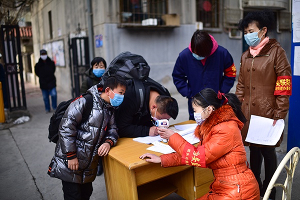  3月3日，在青海省西宁市中庄社区的疫情防控点，志愿者为进入小区的人员做信息登记、体温测量和健康宣传等工作。 新华社 图